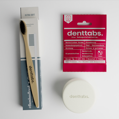 Sustainable Bamboo Toothbrush, a package of strawberry flavoured toothpaste tablets and a jar to store them. Travel kit for sustainable Travellers. Travel with style! That's a perfect summer gadget.